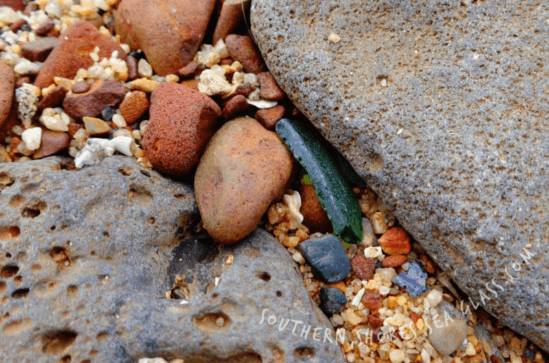 glass shard wedged between rocks